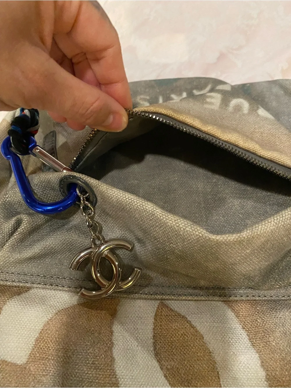 CHANEL Faded Beige Canvas Backpack with Multicolor Strap and Silver-Tone Charm